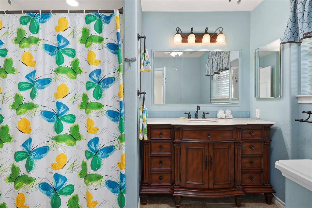 The primary bath features a luxurious walk-in tub with a convenient handheld showerhead.