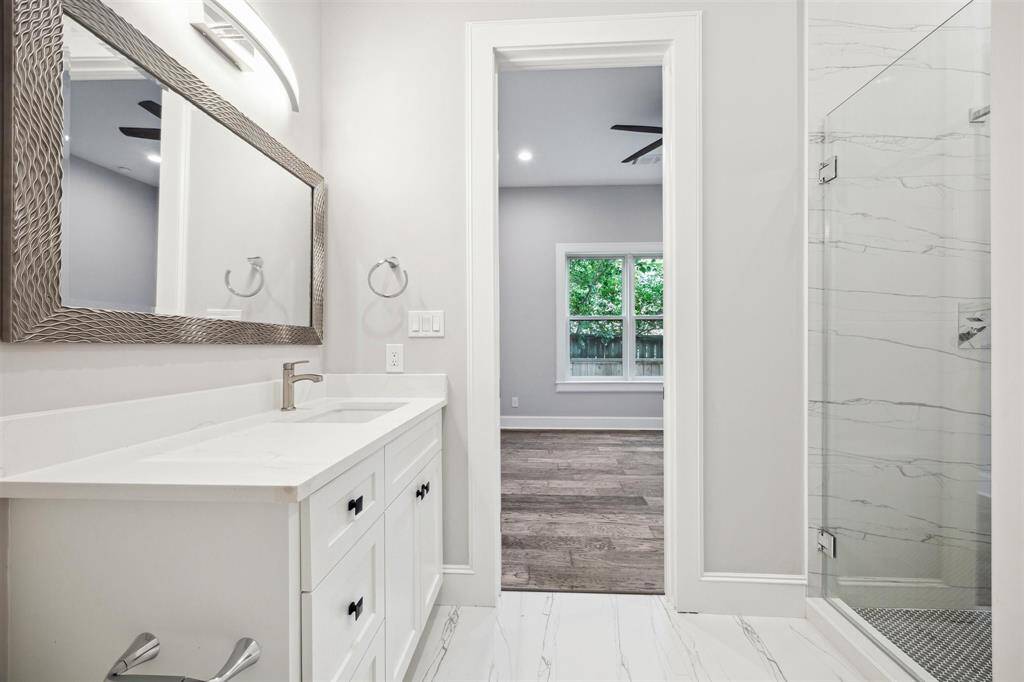 The en-suite bathroom with glass enclosed shower on level one