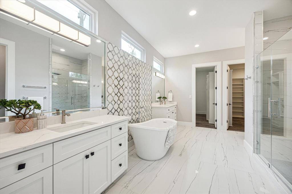 Primary Bathroom with glass enclosed  shower, dual vanities and private w/c