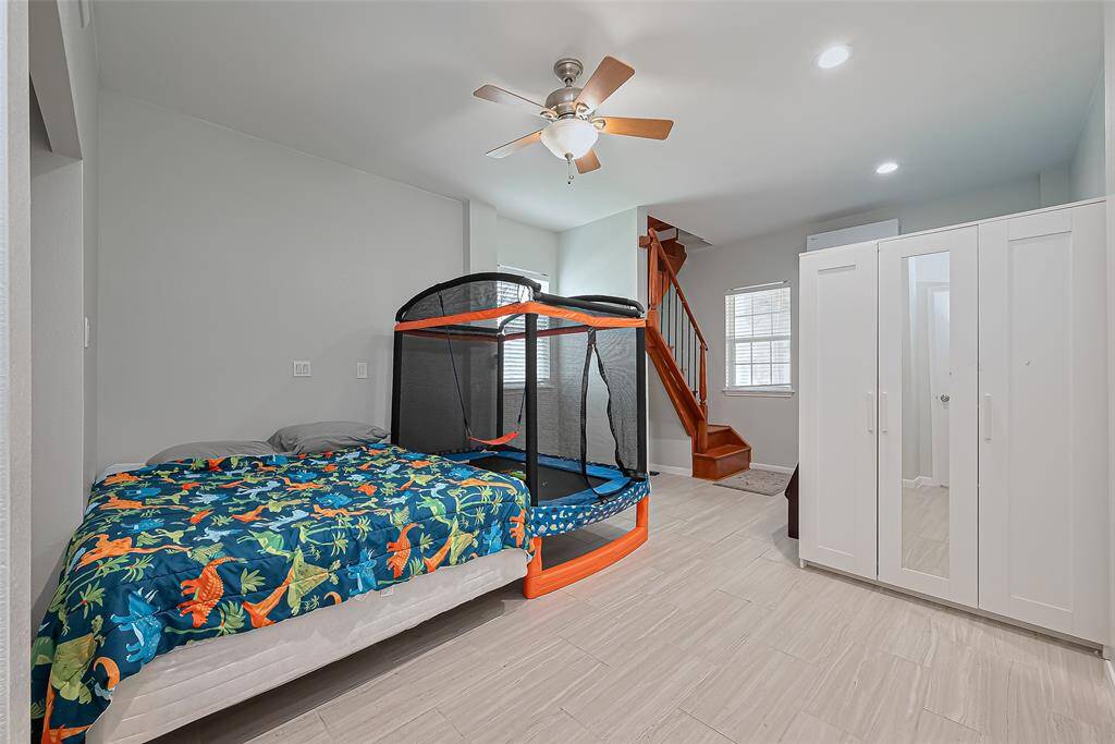 Ample storage and wooden stairs lead to an upper level.