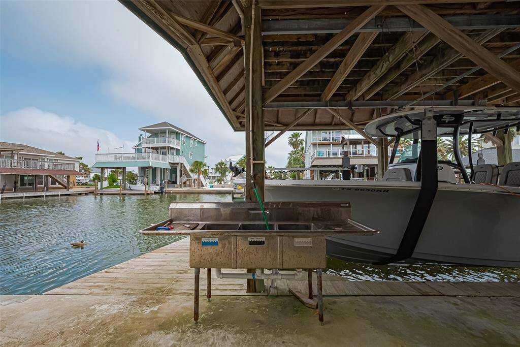 Covered boat dock with a sink, ideal for fishing enthusiasts.