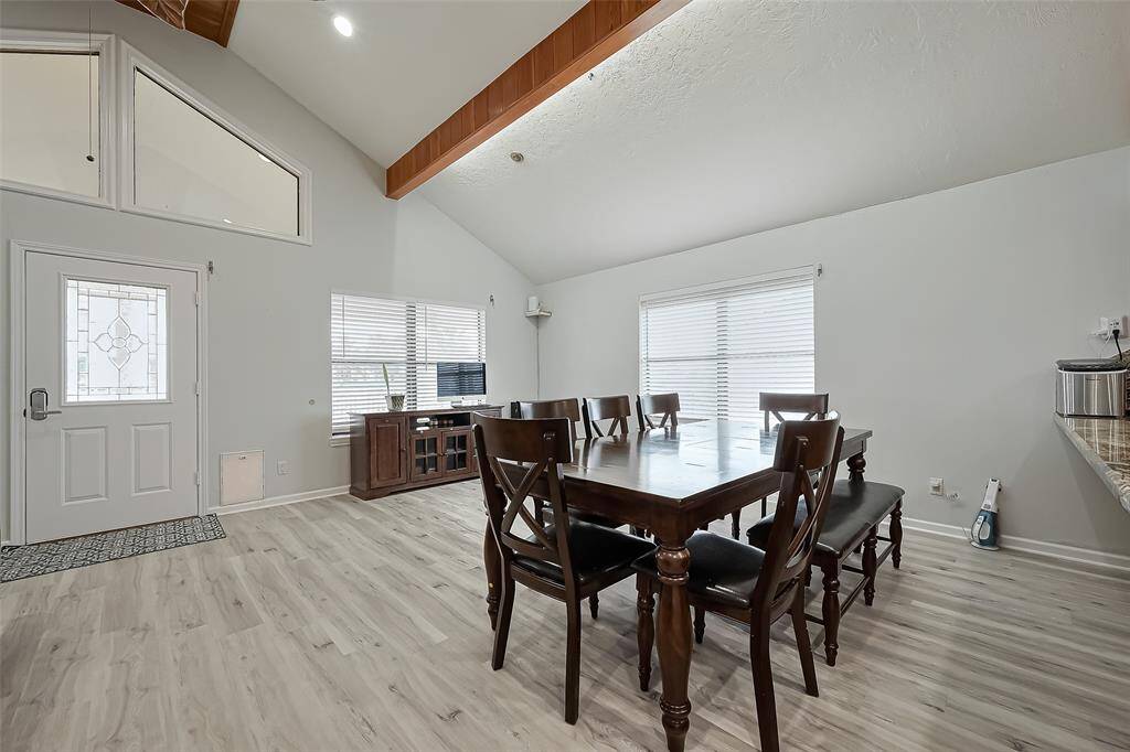 Open dining area with large windows, allowing plenty of natural light.