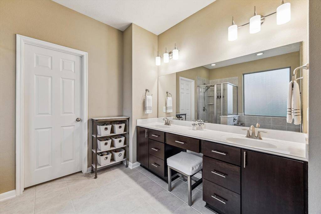 The expansive countertops include a dedicated vanity area, complemented by upgraded cabinetry below for added style and storage.