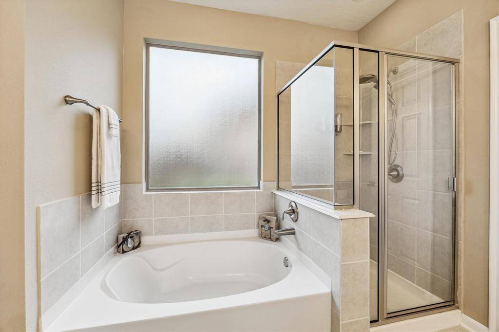Indulge in the separate walk-in shower and luxurious garden tub—perfect for unwinding at the end of the day.