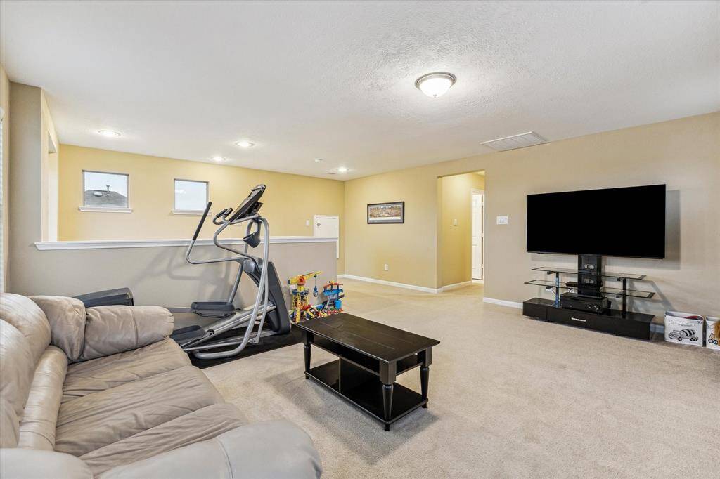 This generously sized game room easily doubles as a versatile multi-purpose space—perfect for work, play, or relaxation.