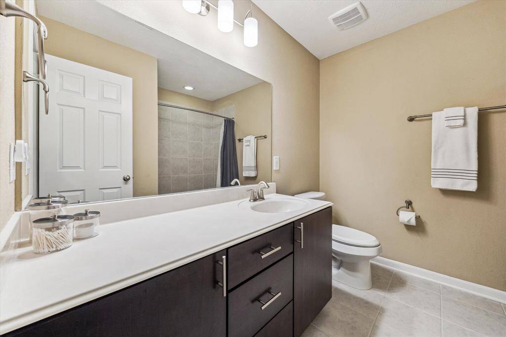 The upstairs full bathroom is both spacious and impeccably maintained, offering comfort and convenience for family or guests.
