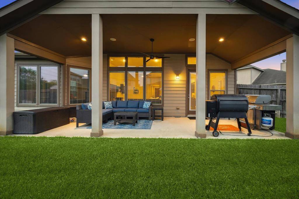 This incredible backyard features a covered patio that's spacious enough to accommodate all your outdoor furniture—and all your guests.