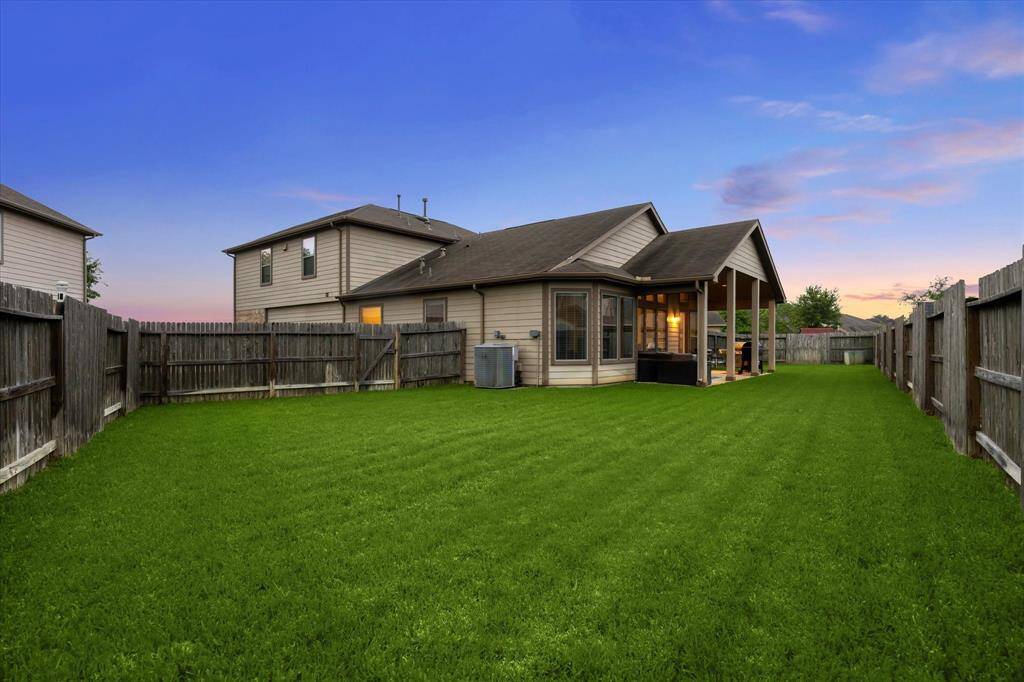 This is one of two generous sections in the expansive backyard, offering plenty of space for play, entertaining, or relaxing.