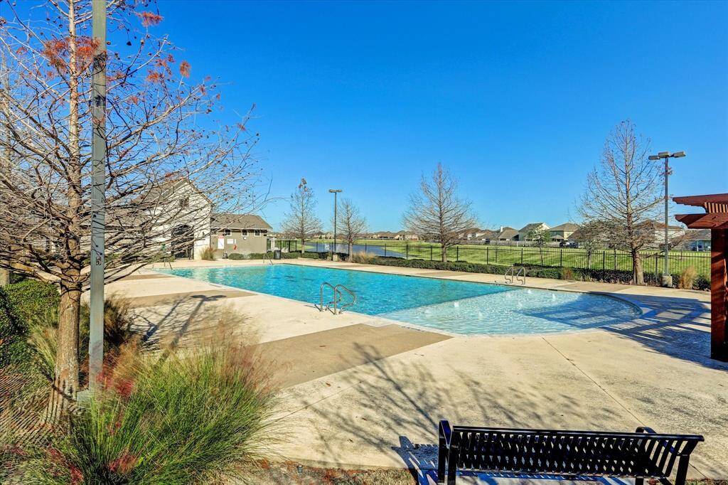 From this angle, you can take in the picturesque lake view that adds a serene backdrop to the pool area.