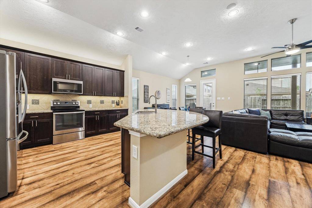 Step into the heart of the home, where a stunning kitchen and an expansive living area welcome you with style and warmth.
