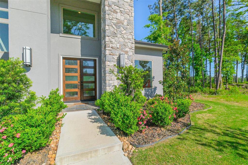 Beautiful stone wall and warm wood and glass doors welcome you and your guests