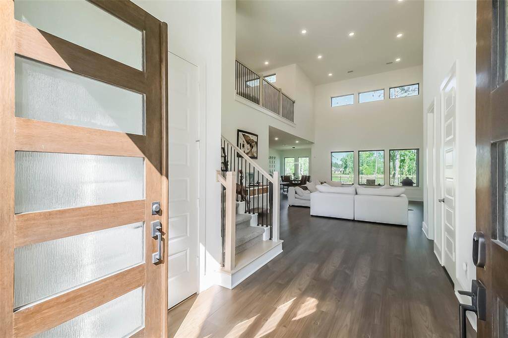Spectacular views as you enter this amazing home! From the 20' ceiling, iron balusters, picturesque windows, on to the lakeside scenery out back.