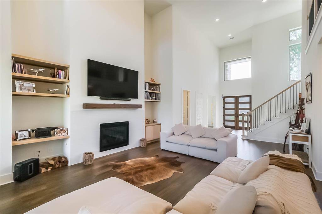 Gaslog fireplace and built in shelves and cabinets add warmth, along with the engineered wood flooring that flows throughout the first floor.