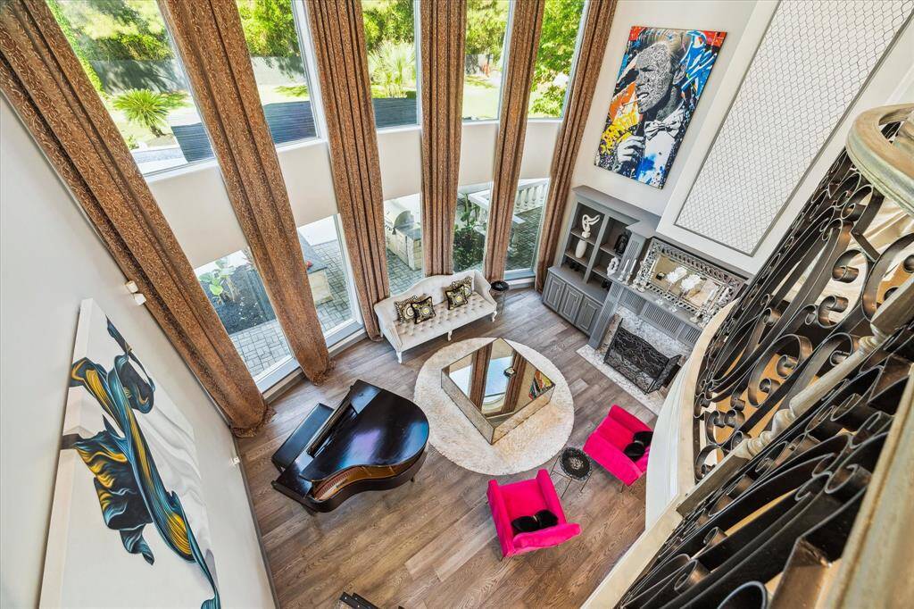 This spacious living room features floor-to-ceiling windows. It has an open, airy feel and is perfect for entertaining or relaxing.