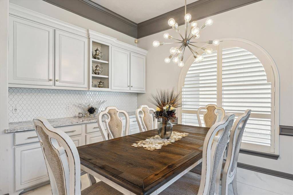 The breakfast area has beautiful arched windows and additional cabinetry for kitchen storage.