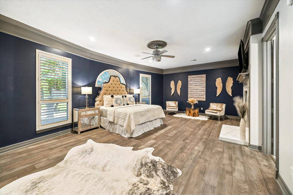 The primary bedroom features a fireplace that is built into the wall and can be viewed in the next photo through the primary bath as well.