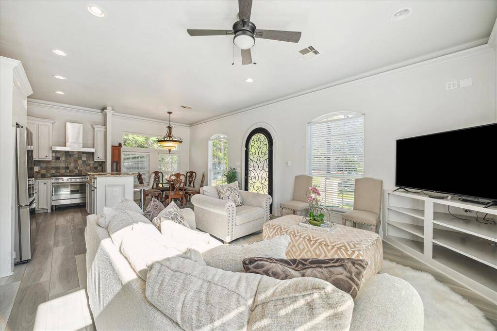 This spacious 3-car garage is partially used as a home gym. The flooring in the garage is fully epoxy and not pictured is additional parking space as well as a bump out for extra storage.