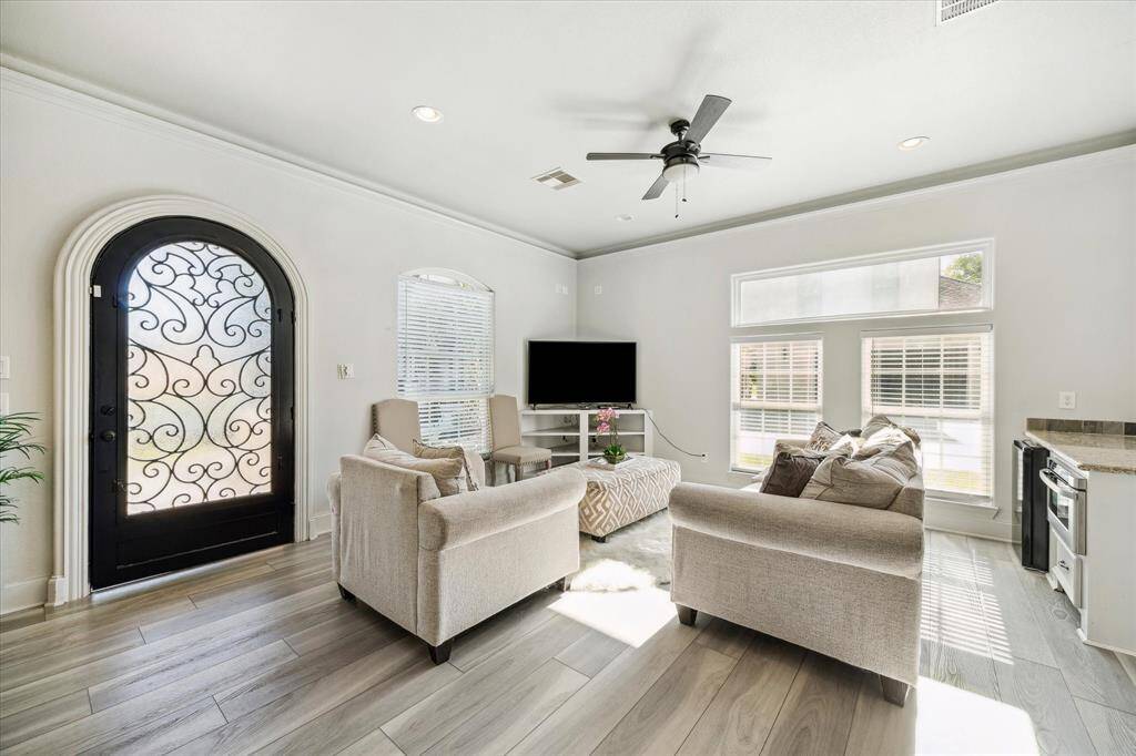 Welcome to the GUEST HOUSE! This spacious open-concept living area features modern finishes, a cozy seating arrangement, and abundant natural light. The kitchen boasts stainless steel appliances and a stylish backsplash, while the adjacent dining area offers a seamless flow for entertaining.