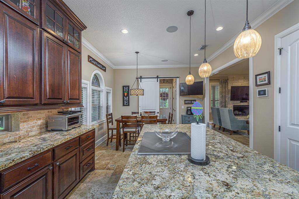 The massive kitchen island features a hibachi grill and barstool seating.