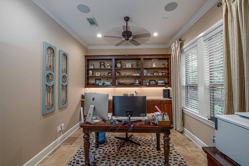 Office with massive custom built-in shelving and drawers.