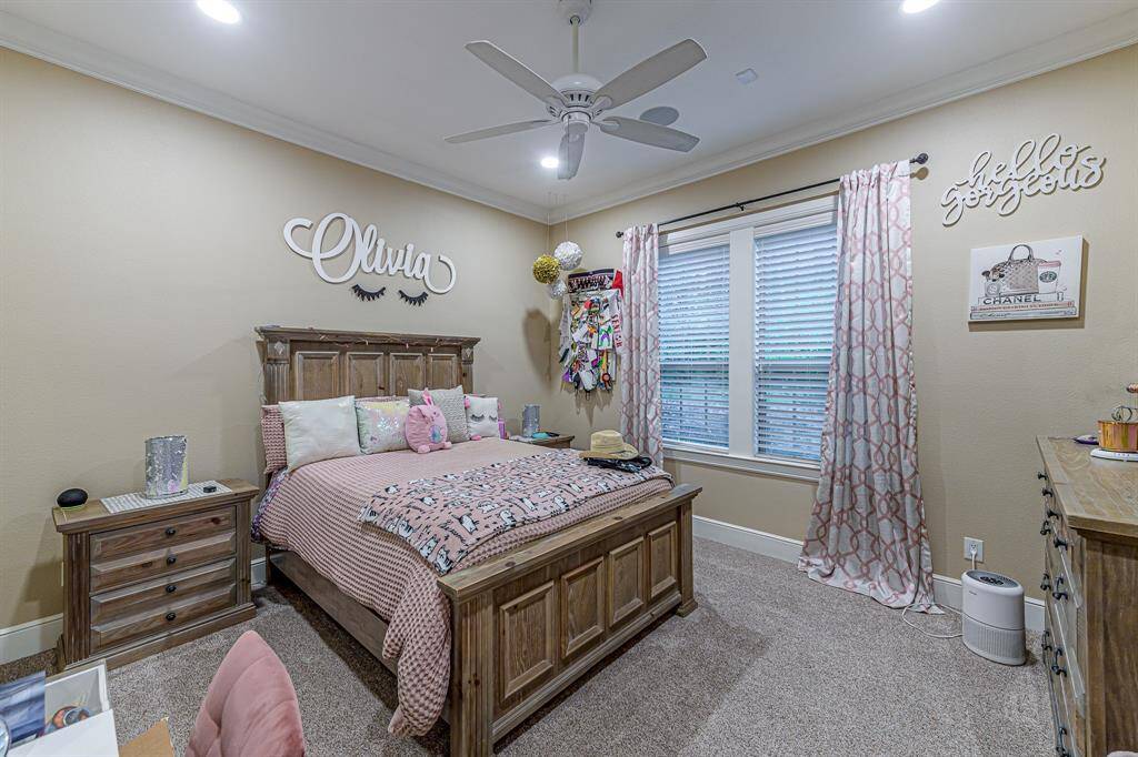 Another spacious guest bedroom with an en-suite bath and closet containing custom built-in shelving.