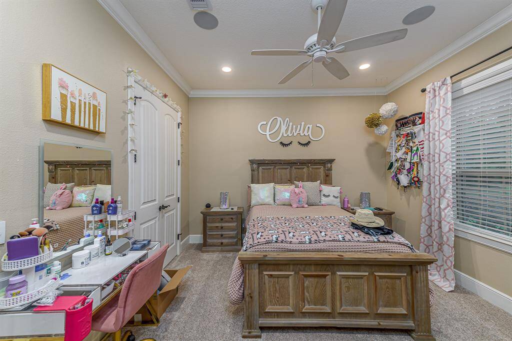Another spacious guest bedroom with an en-suite bath and closet containing custom built-in shelving.