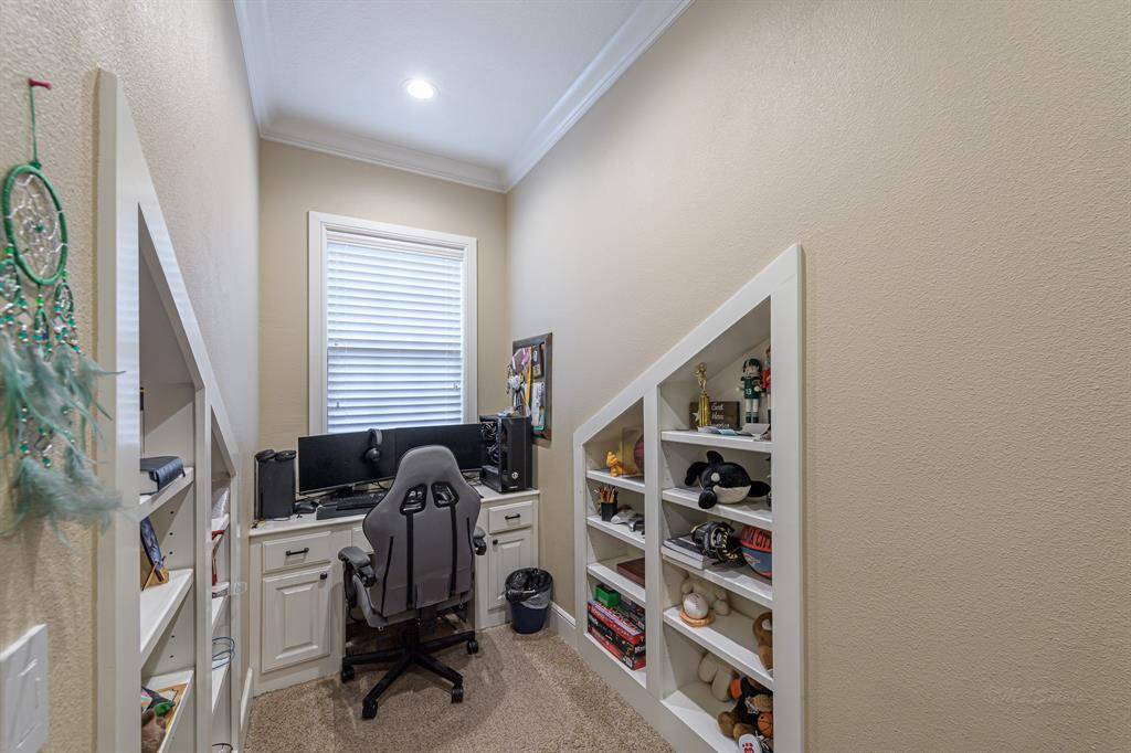 Dormer with custom built-in desk and shelving in upstairs bedroom.