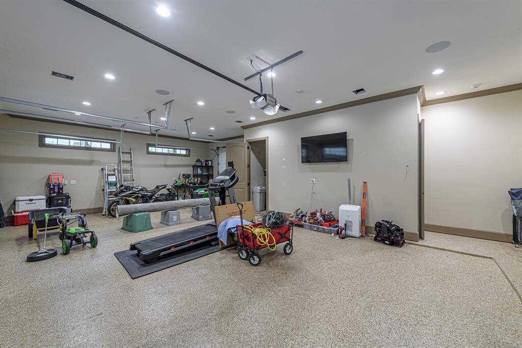 Massive 3-bay garage with epoxy flooring. Stairs lead up to the unfinished garage apartment. Garage refrigerators are NOT included in the sale.