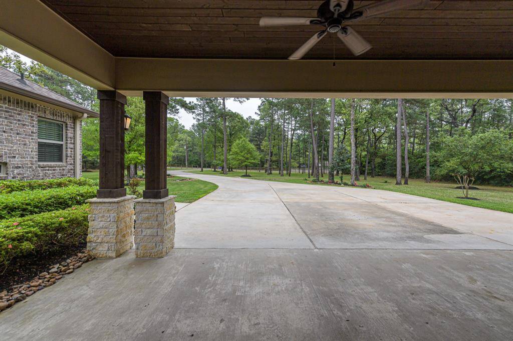 Close up of carport which has several fans, recessed cans, and speakers.