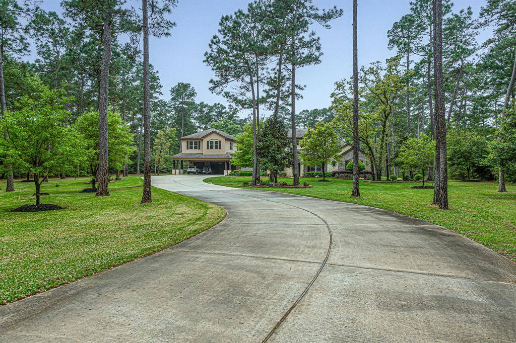 Long, winding, doublewide driveway. The end of the driveway is wired for electric gate and intercom.
