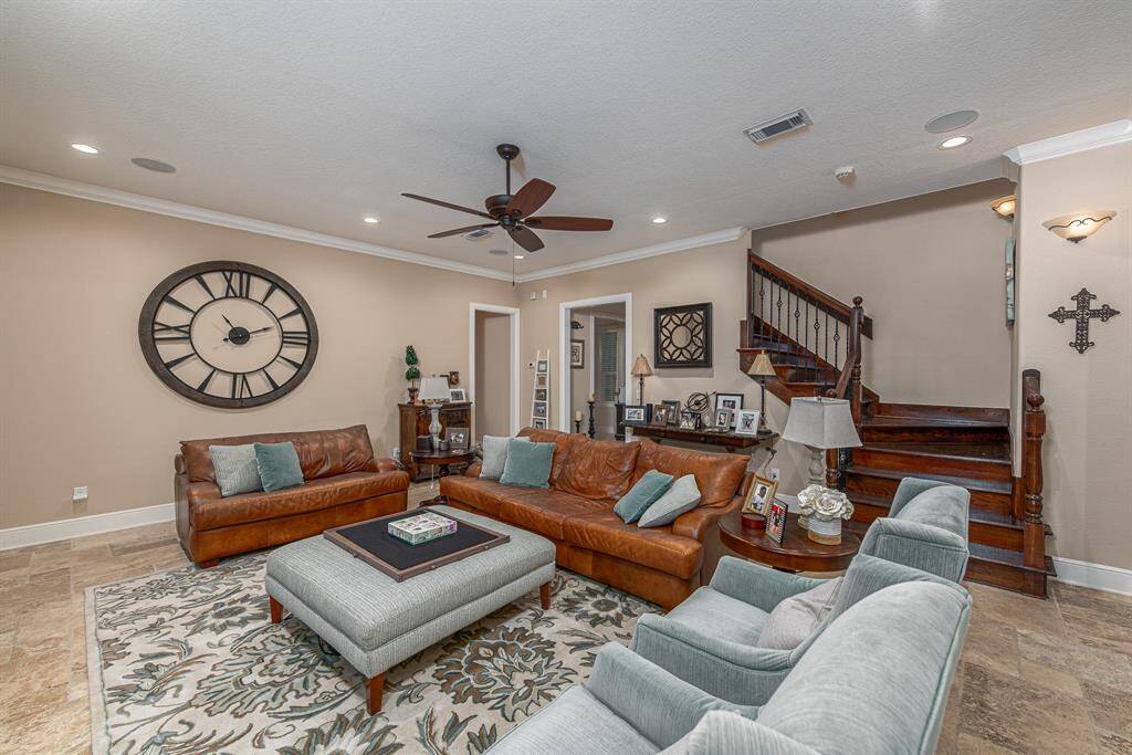 Spacious living room that branches off into the kitchen on the right and entryway.