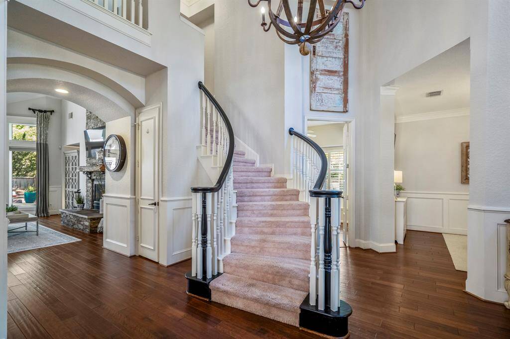 Elegant curved staircase ascends to three inviting upstairs rooms.