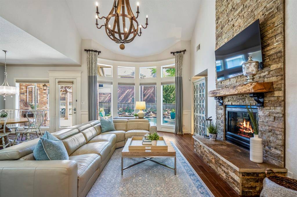 Cozy living room with a striking stone fireplace and expansive windows that bathe the space in natural light.