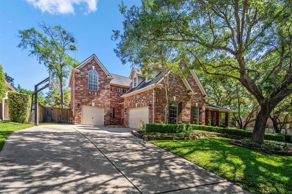 Spacious three-car garage with an extended driveway for abundant parking.