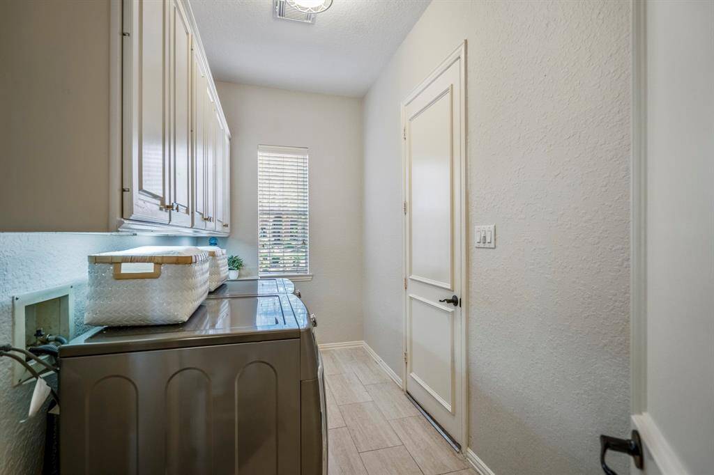 Convenient laundry room with direct access to a second garage.
