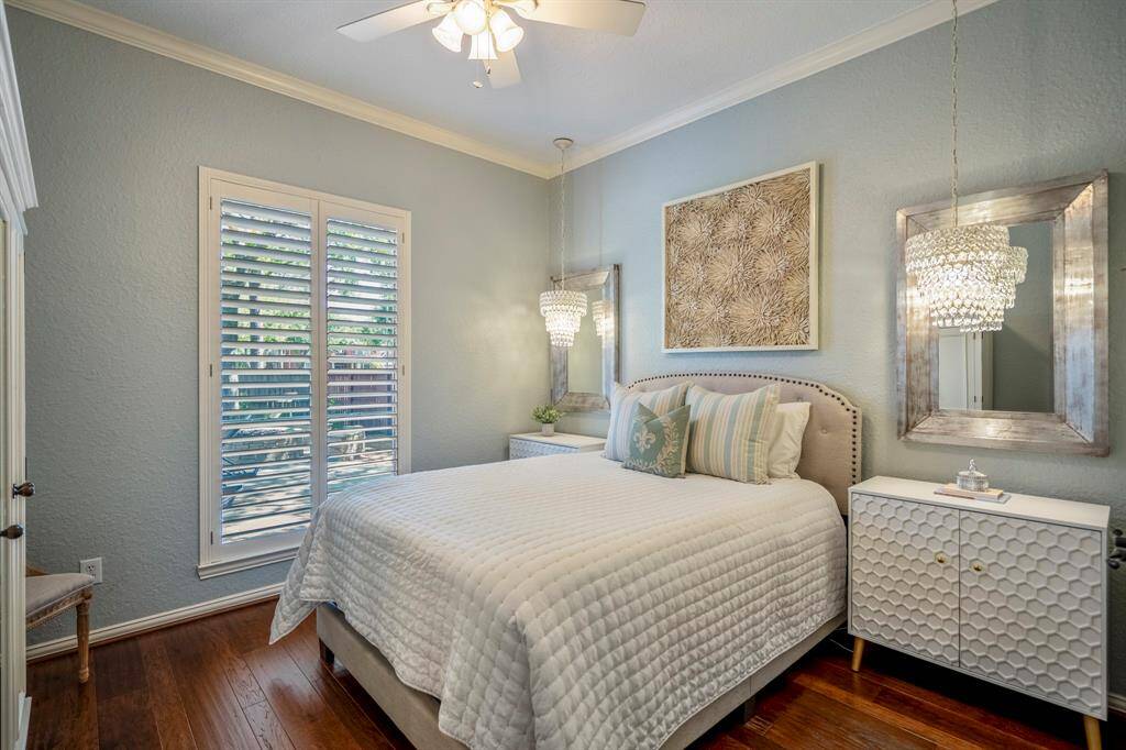 Cozy downstairs bedroom with elegant decor and abundant natural light.