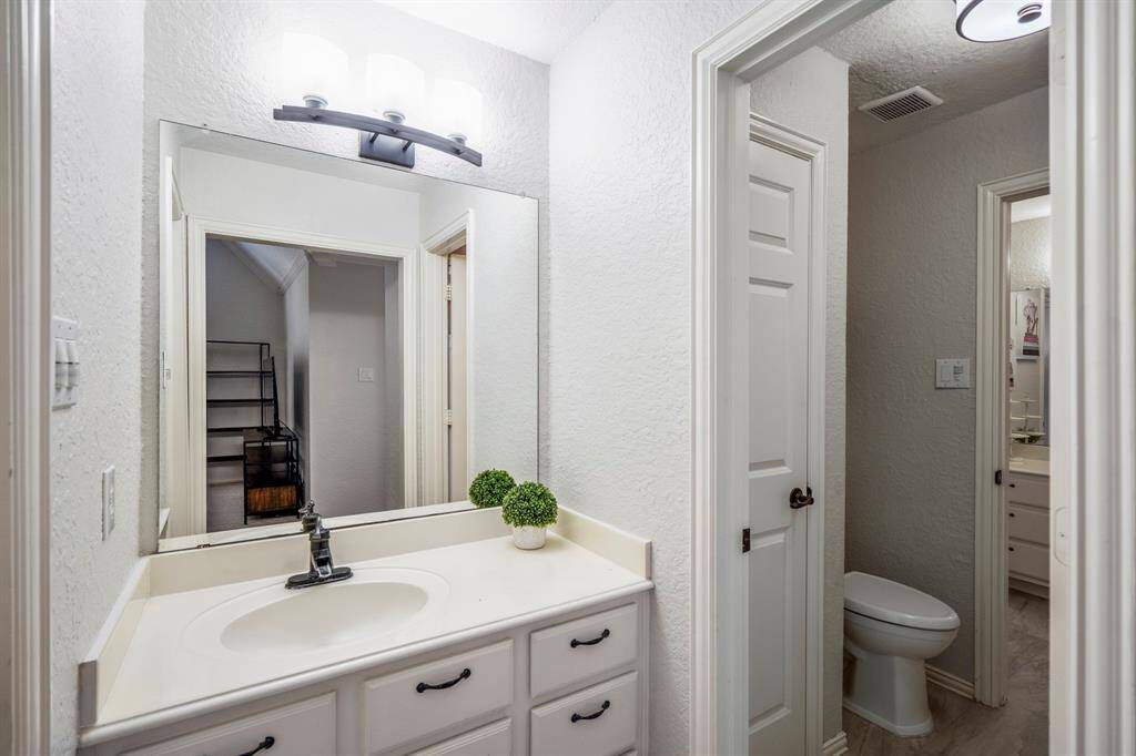 Convenient ensuite half-bath in the second bedroom that is attached to the shared full bathroom.