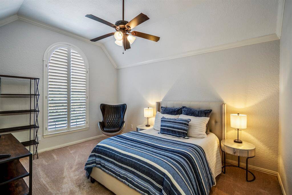 Upstairs second bedroom with beautiful arched window that brings in natural light.