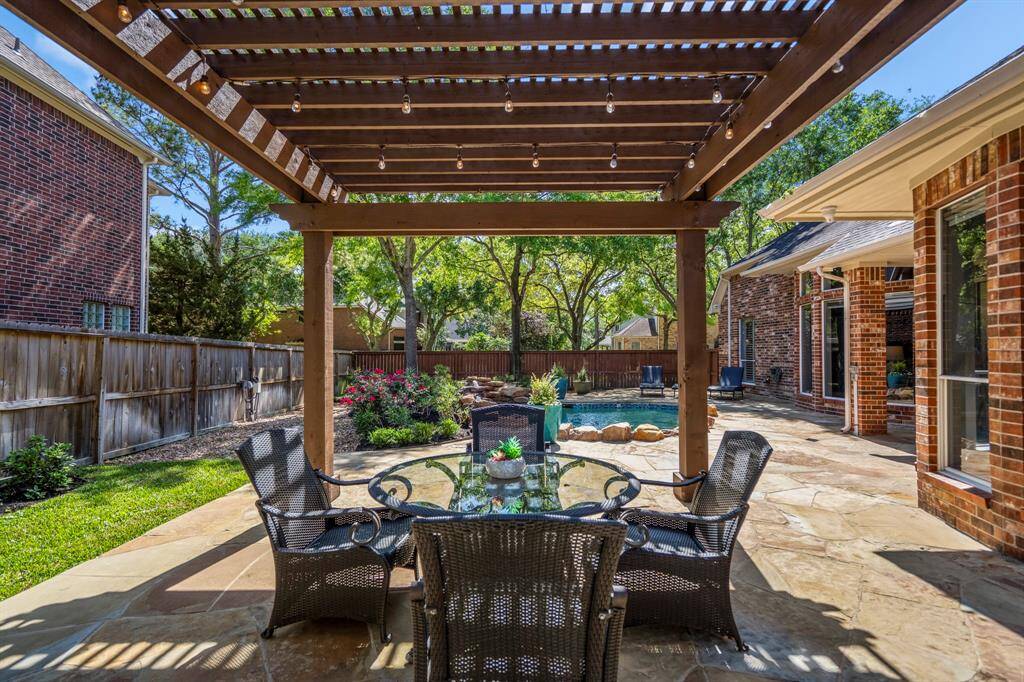 Ideal for entertaining, this backyard oasis features a pergola, pool, and lush landscaping—perfect for hosting unforgettable gatherings.
