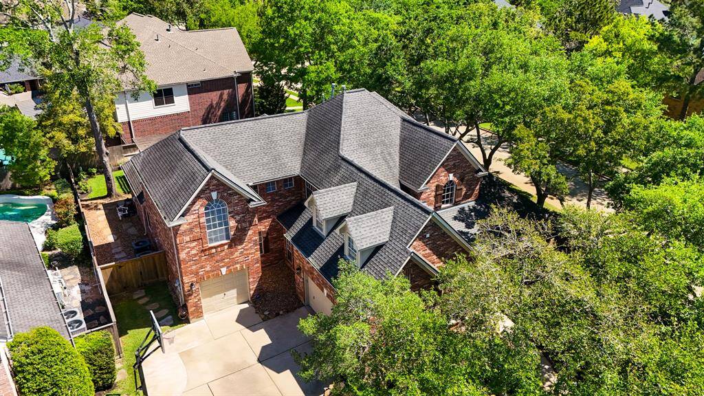 A stunning aerial view showcases the home's elegant architecture and lush surroundings, highlighting its prime location and inviting atmosphere.
