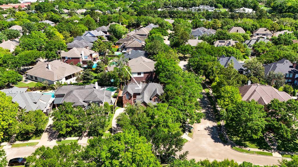 Discover your dream home nestled in a lush, vibrant neighborhood with stunning aerial views showcasing its serene surroundings.