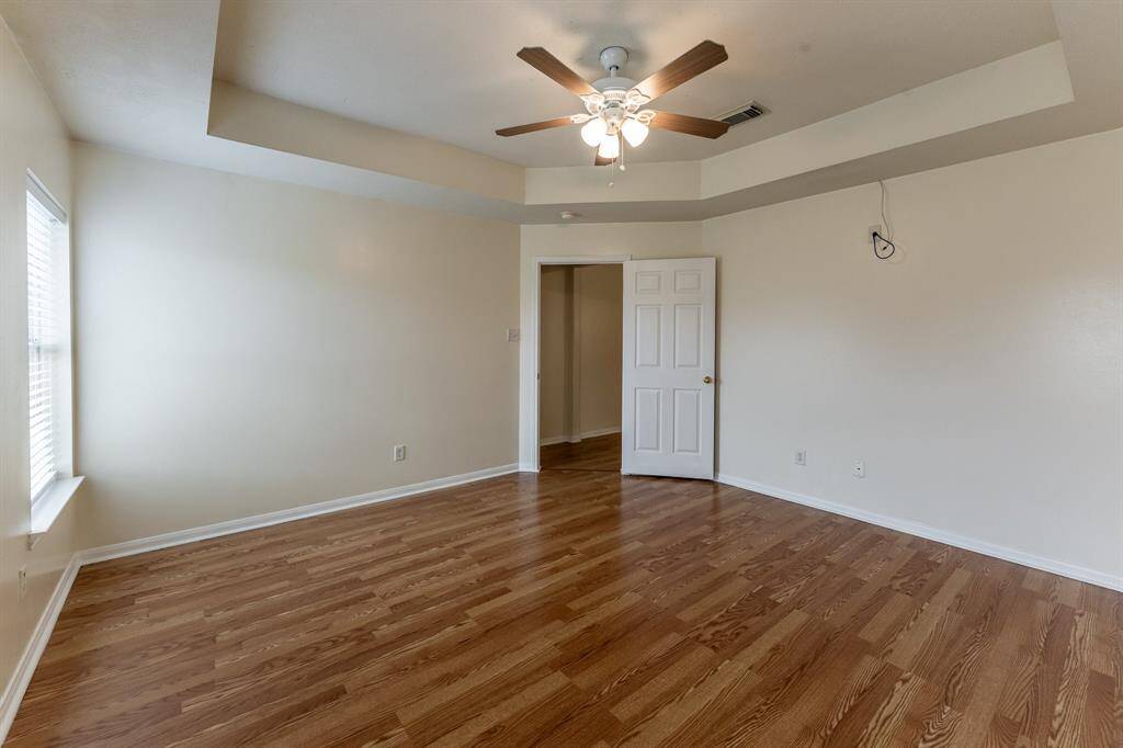 Primary Bedroom iwth a ton of natural light and stylish tray ceilings.