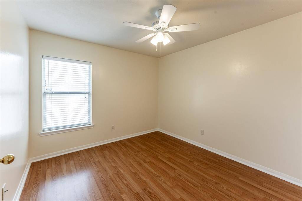 Secondary bedroom with tall ceilings and abundant natural light.