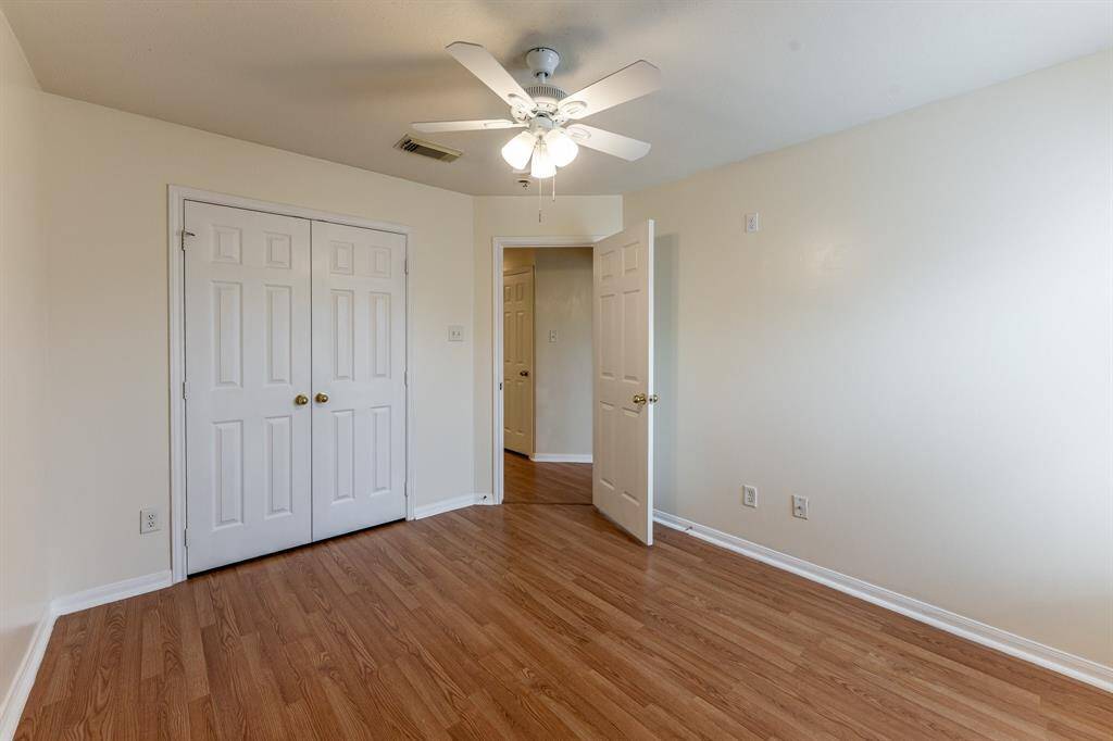 Secondary bedroom with tall ceilings and abundant natural light.