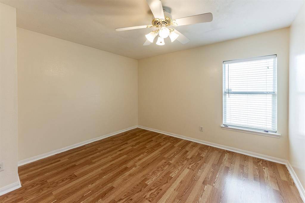 Secondary bedroom with tall ceilings and abundant natural light.