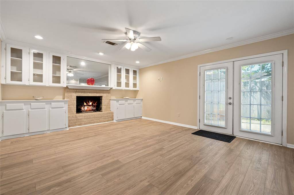 Just off the kitchen, this versatile butler’s pantry features built-in cabinetry, abundant natural light, and convenient access to the side yard.