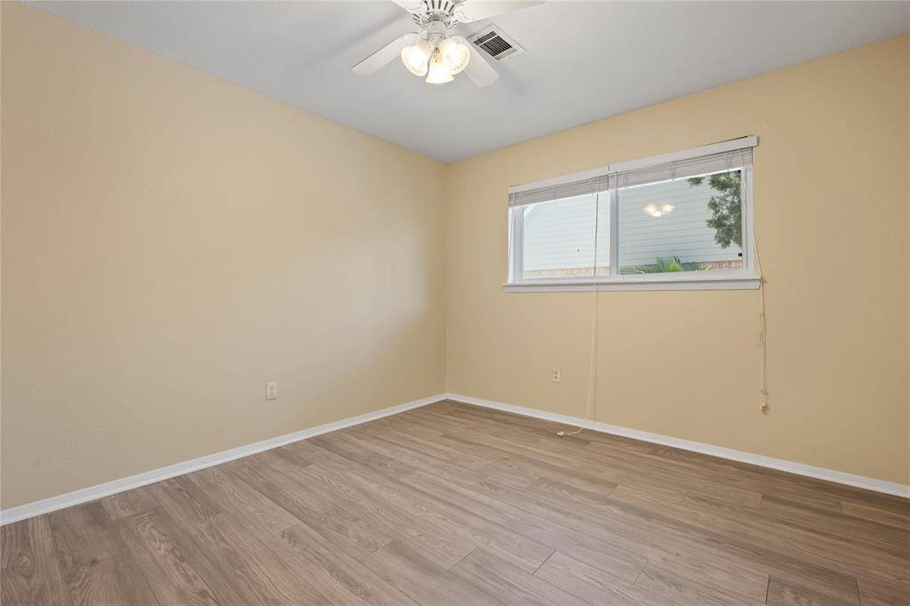Primary bedroom includes double glass doors leading to backyard patio.