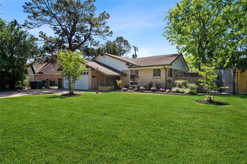 The exterior features a combination of brick and wood siding, offering a welcoming and cozy curb appeal.