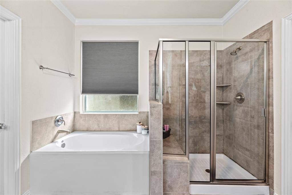 Primary bath provides both a soaking tub and a generously sized shower with built-in bench.