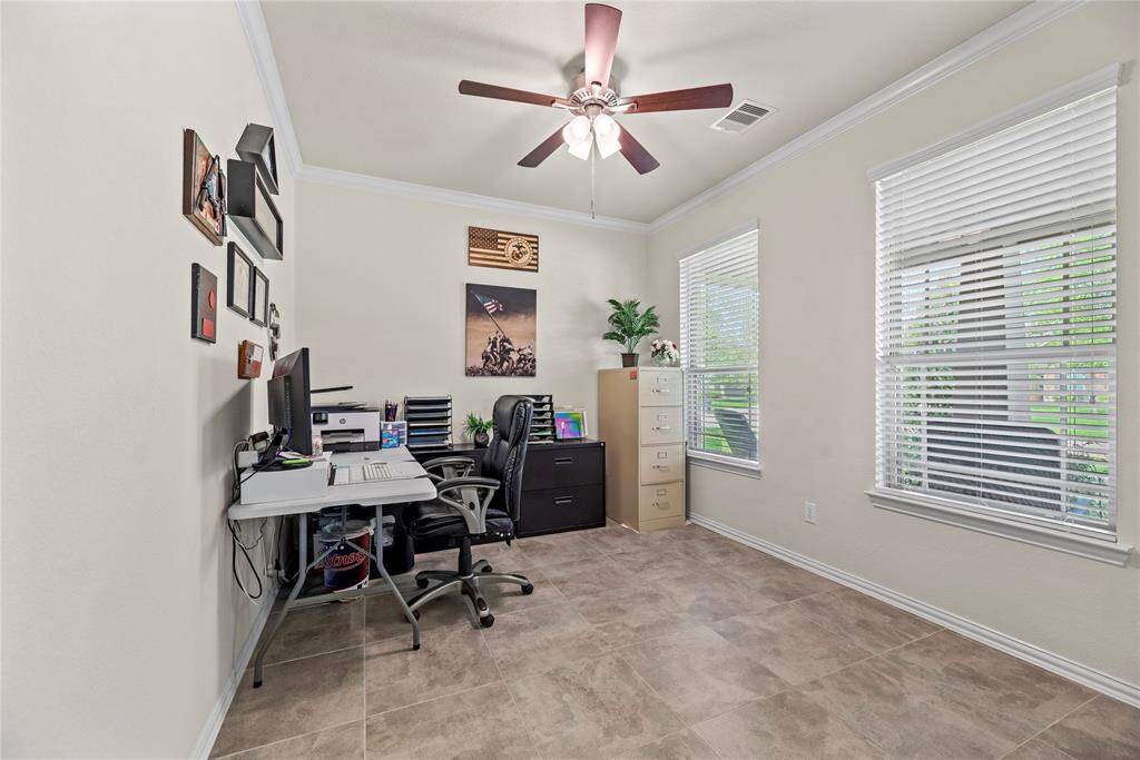 This room could be the formal dining room, but is currently being used as a home office/study.